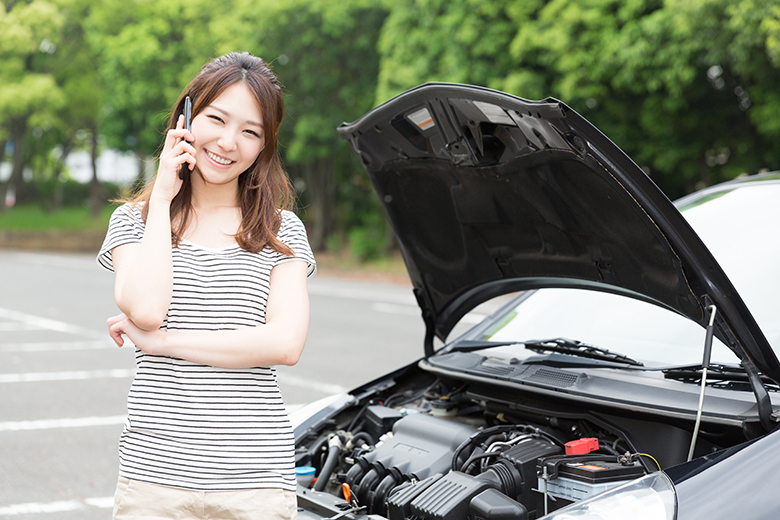 Girl on phone by car